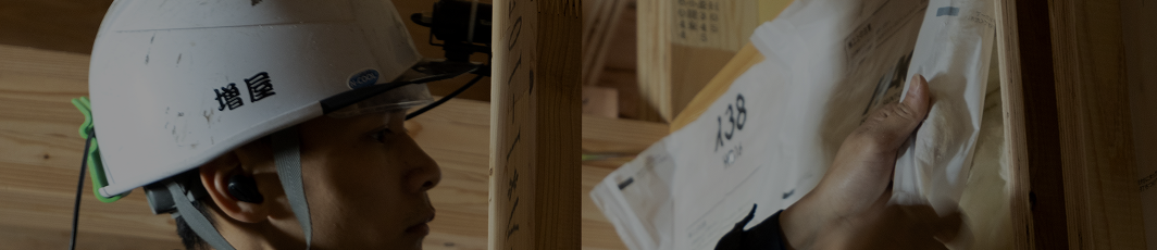 ヘルメットを着用した作業員と断熱材施工の現場